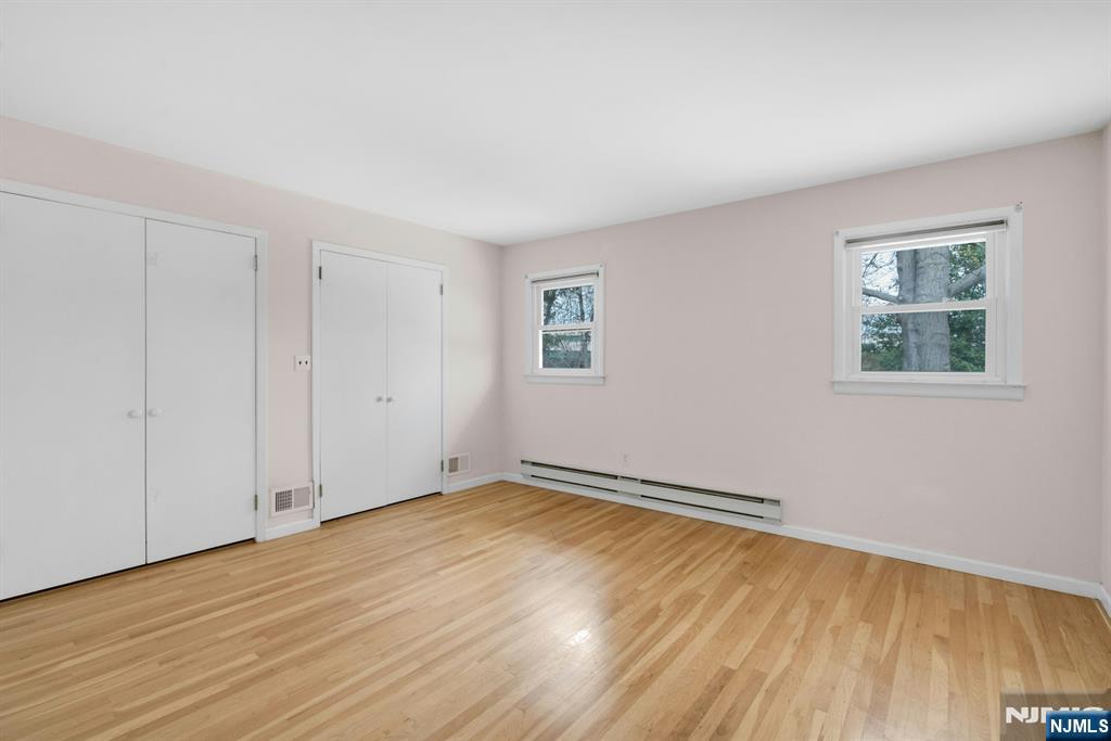 9 Hemlock Drive Paramus, NJ 07652 - Photo 24 of 35 a view of an empty room with wooden floor and a window