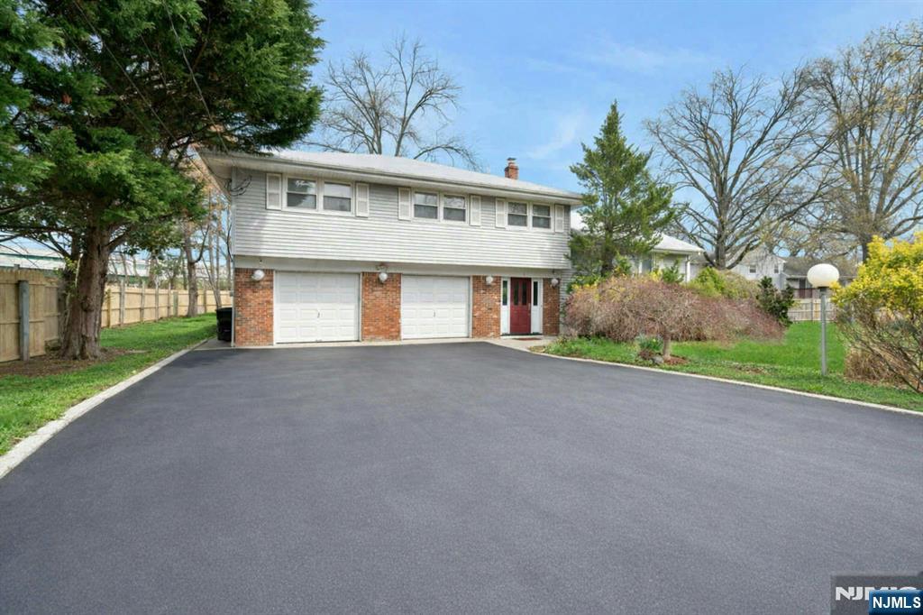 9 Hemlock Drive Paramus, NJ 07652 - Photo 3 of 35 a view of a house with a yard and garage