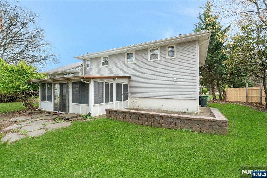 9 Hemlock Drive Paramus, NJ 07652 - Photo 31 of 35 a front view of a house with a yard and garage