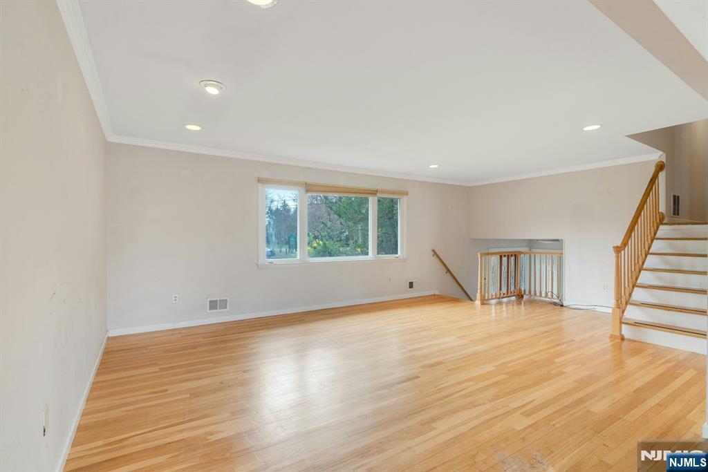 9 Hemlock Drive Paramus, NJ 07652 - Photo 6 of 35 a view of an empty room with wooden floor and a window