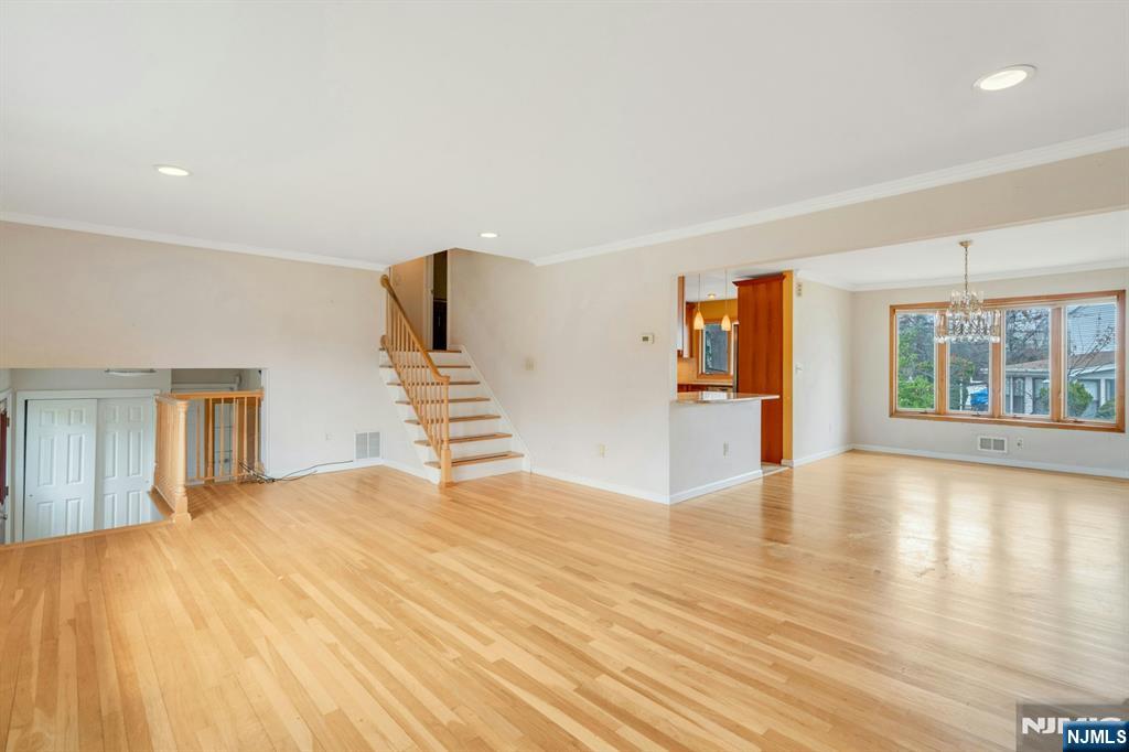 9 Hemlock Drive Paramus, NJ 07652 - Photo 9 of 35 a view of an empty room with wooden floor and windows