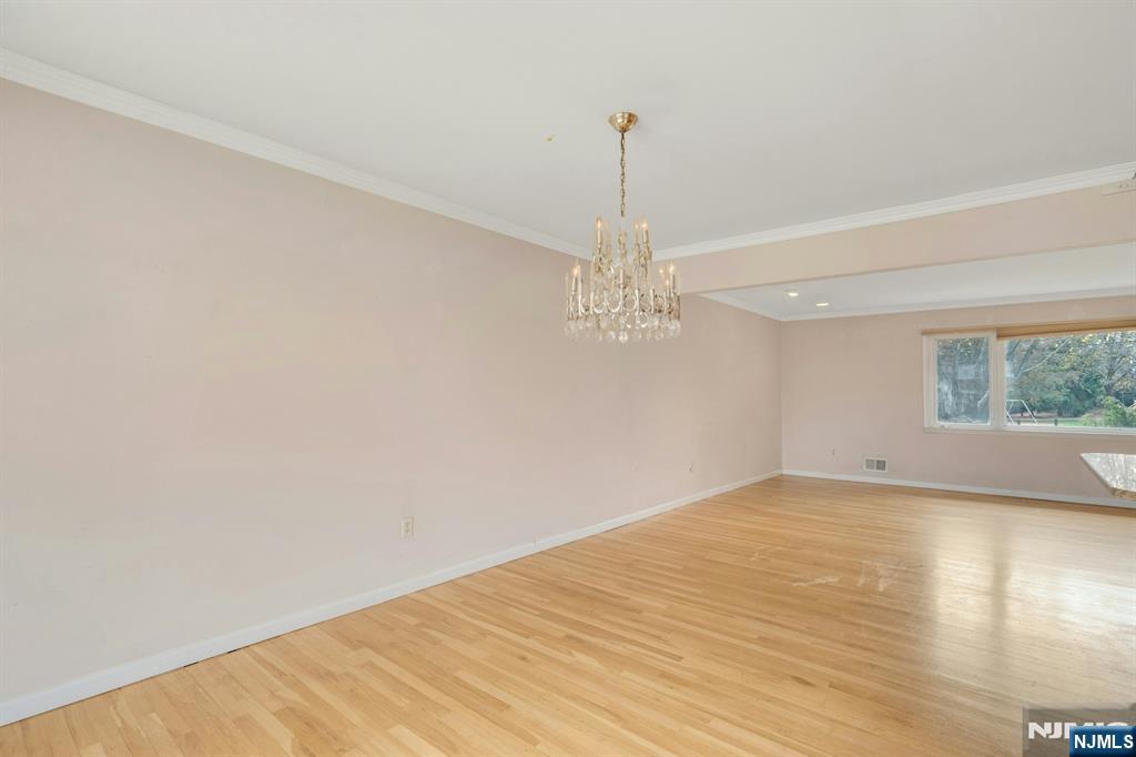 9 Hemlock Drive Paramus, NJ 07652 - Photo 10 of 35 a view of a big room with wooden floor chandelier and windows