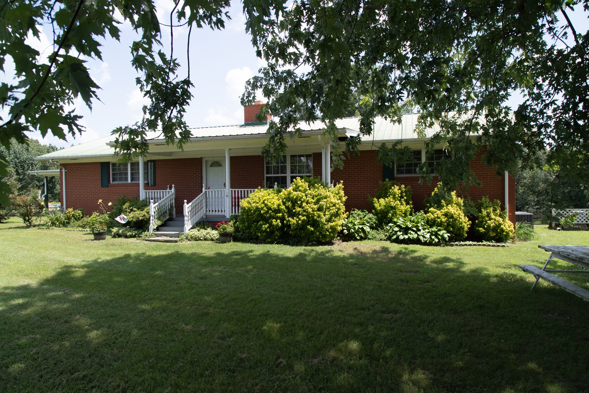 a front view of house with yard and green space