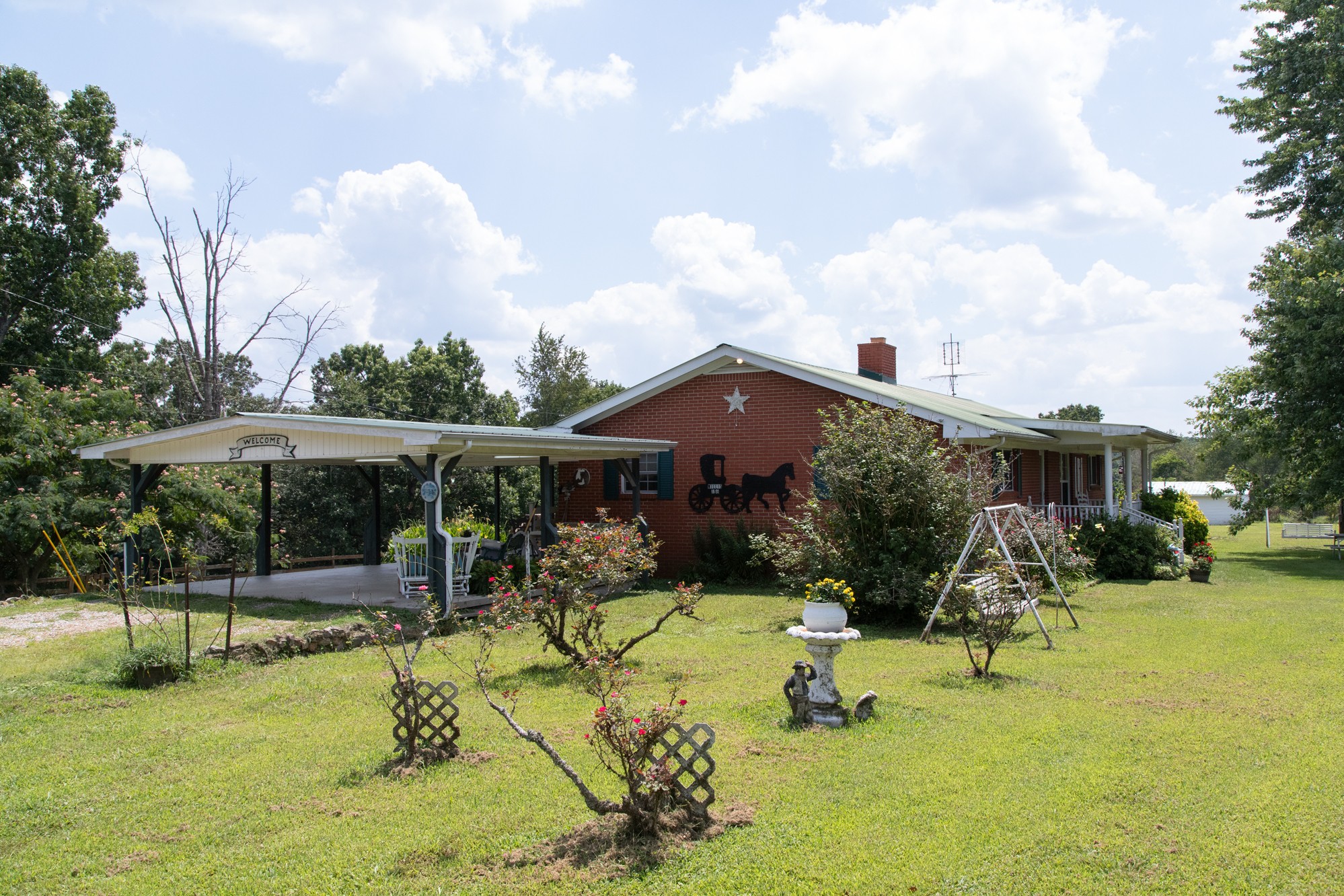 159 Trace Creek Road Hohenwald, TN 38462 - Photo 2 of 42 a view of a swimming pool with a patio