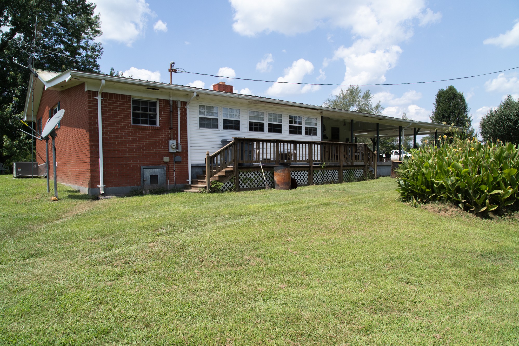 159 Trace Creek Road Hohenwald, TN 38462 - Photo 12 of 42 a view of a house with backyard and porch