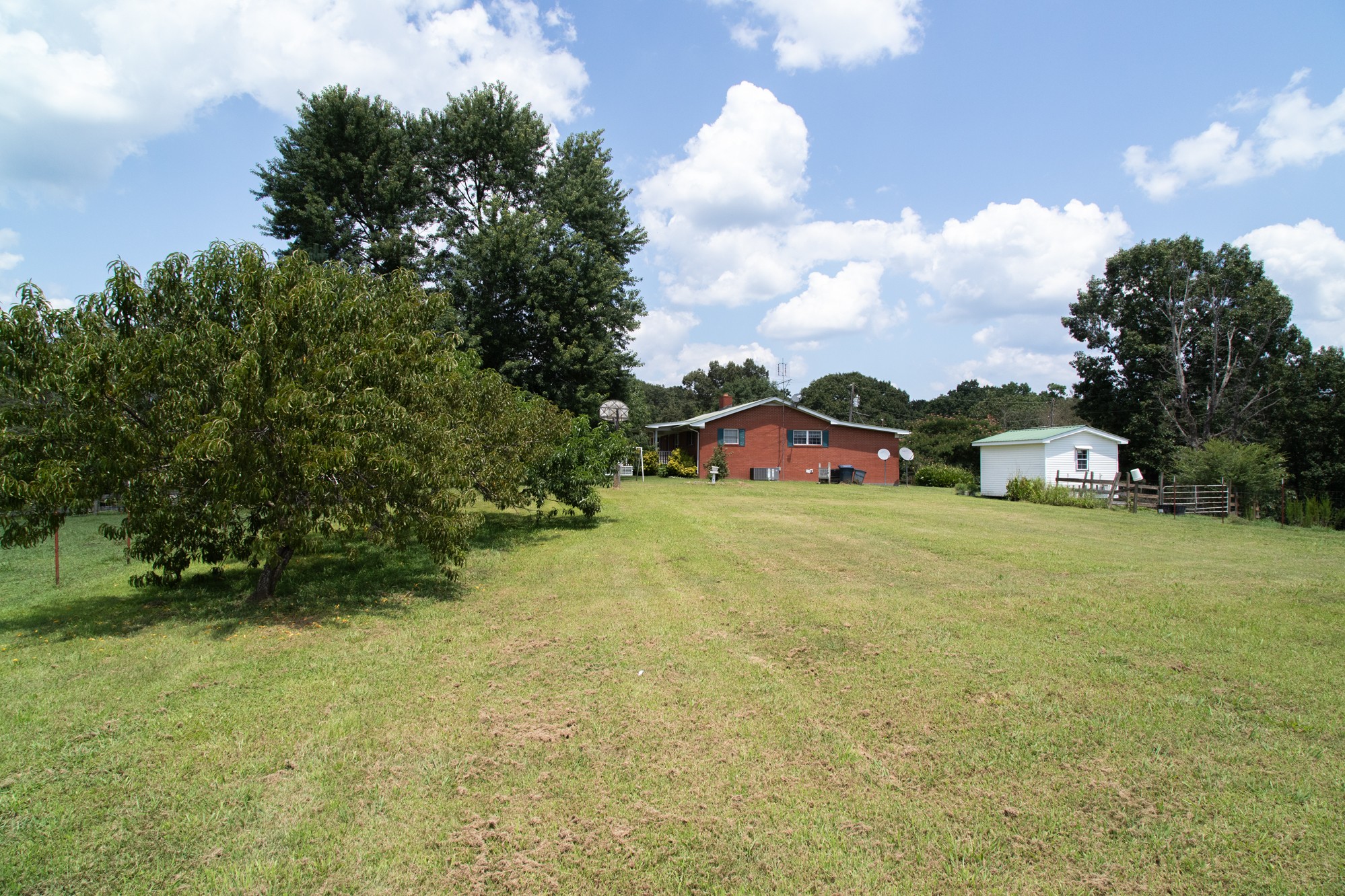 159 Trace Creek Road Hohenwald, TN 38462 - Photo 4 of 42 a front view of a house with a yard and garage