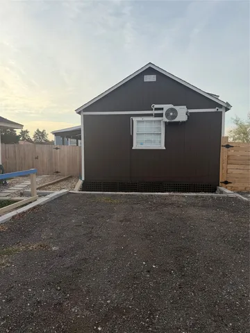 a black car parked in front of a house
