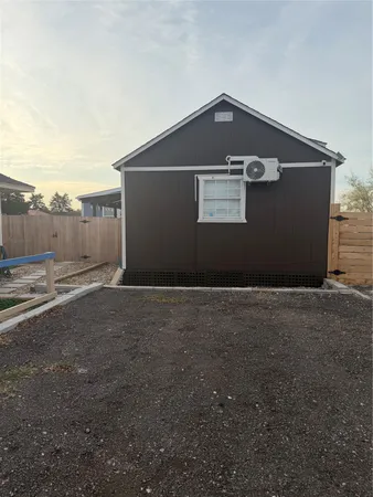 a black car parked in front of a house
