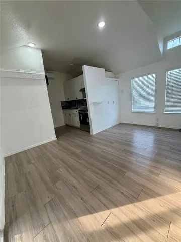 a view of a hallway with wooden floor and a fireplace
