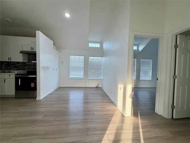 a view of a hallway with wooden floor and a fireplace