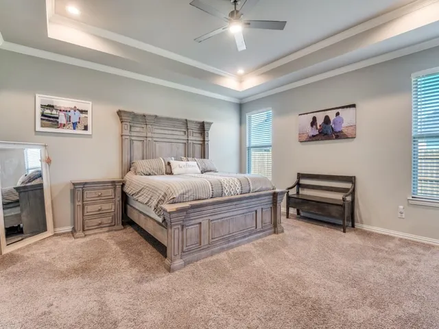 a bedroom with a bed and a chandelier