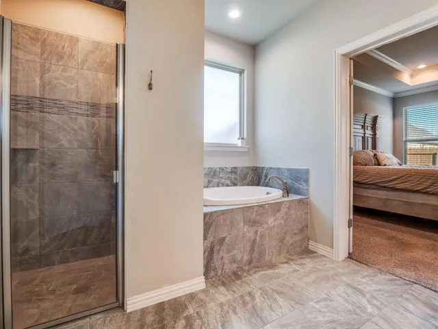 a en suite bathroom with a granite countertop sink and a mirror