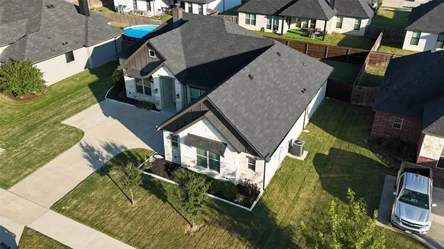 an aerial view of a house with swimming pool