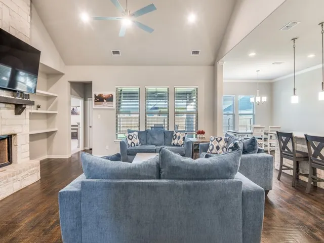 a living room with fireplace furniture and a flat screen tv