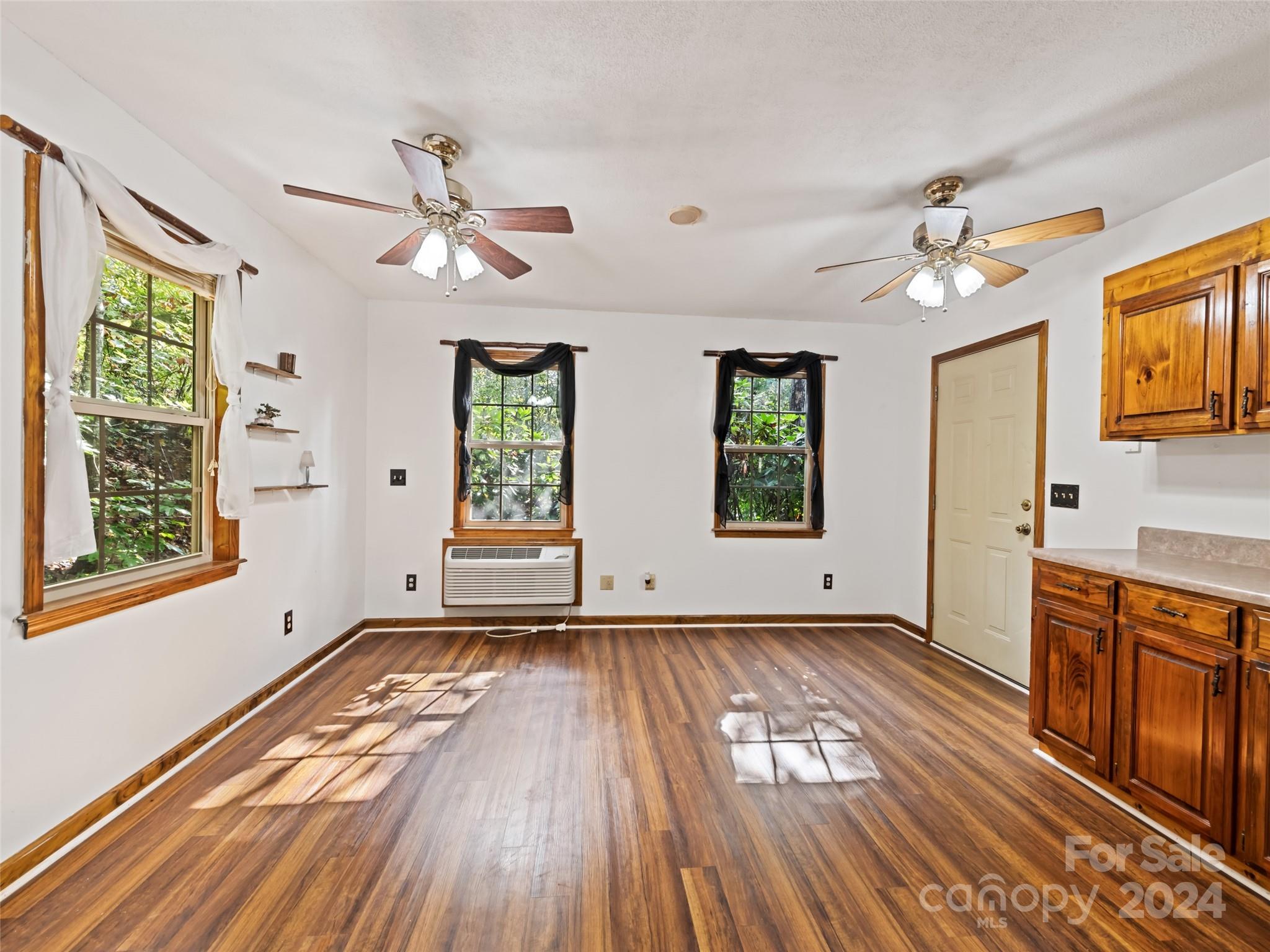 626 Rustic Heights Road Waynesville, NC 28785 - Photo 11 of 18 wooden floor in an empty room with a window