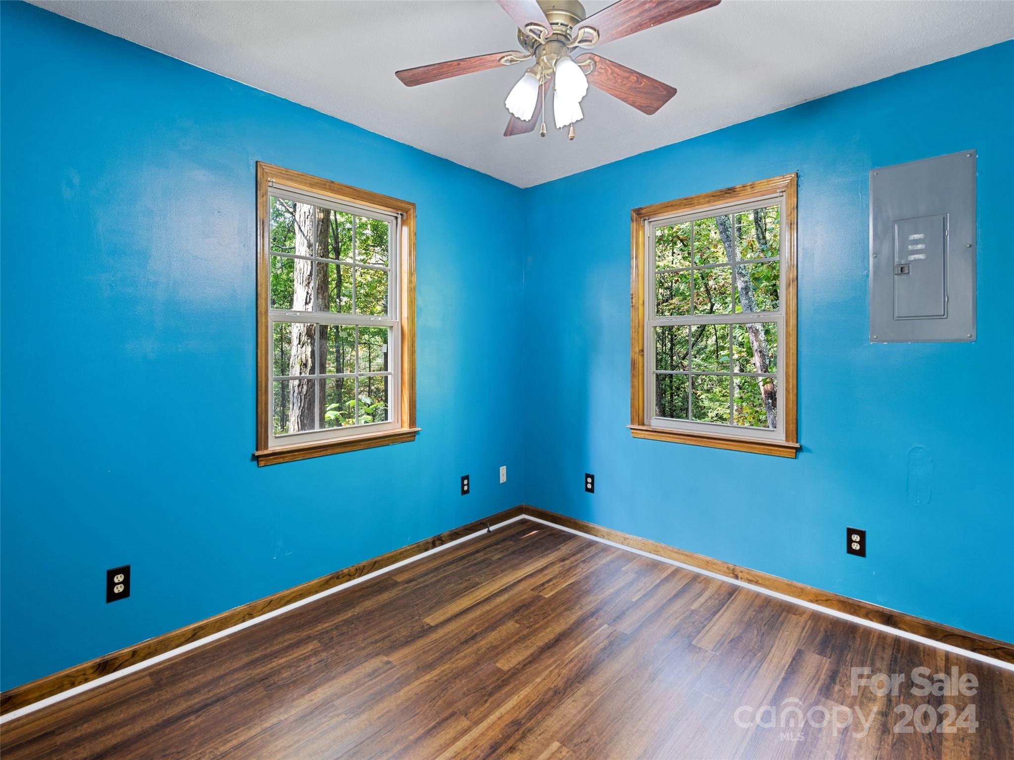 626 Rustic Heights Road Waynesville, NC 28785 - Photo 16 of 18 a view of empty room with wooden floor and fan