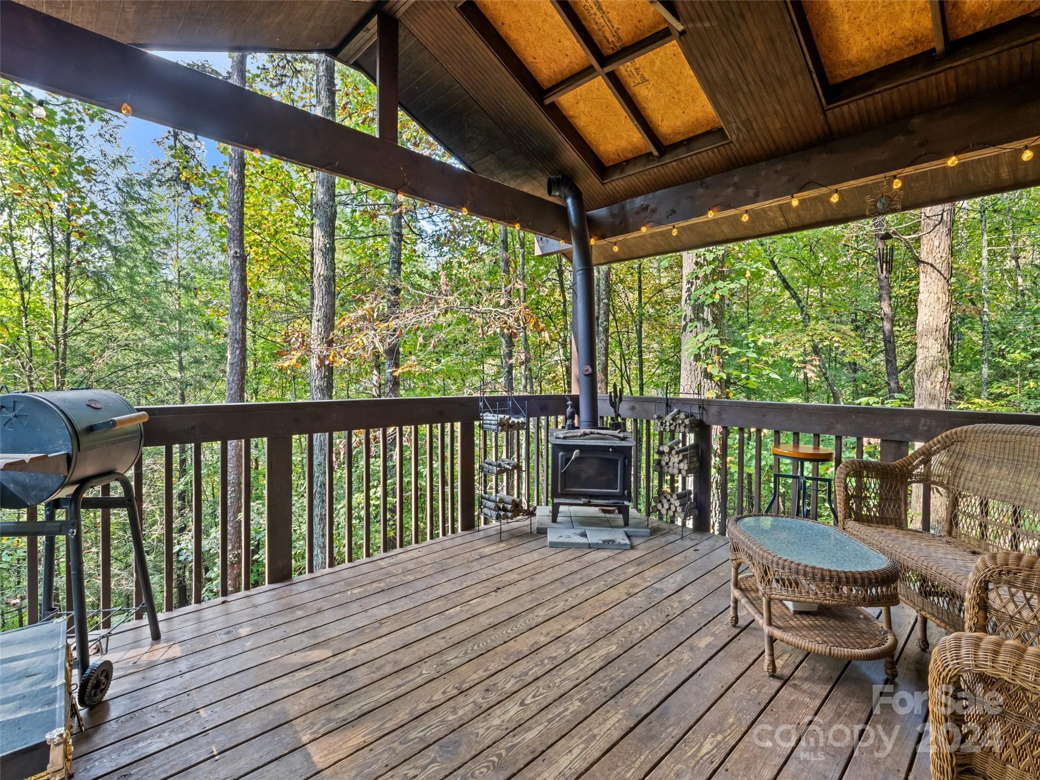 626 Rustic Heights Road Waynesville, NC 28785 - Photo 4 of 18 a view of a two chairs on the deck