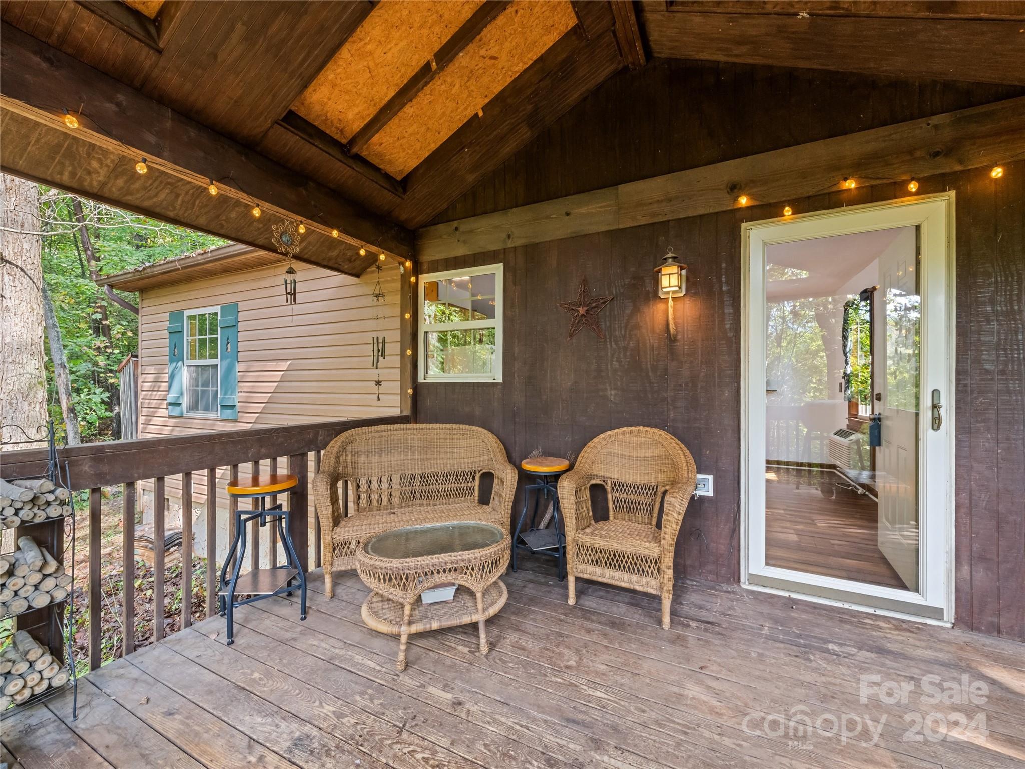 626 Rustic Heights Road Waynesville, NC 28785 - Photo 6 of 18 a front view of a house with outdoor seating