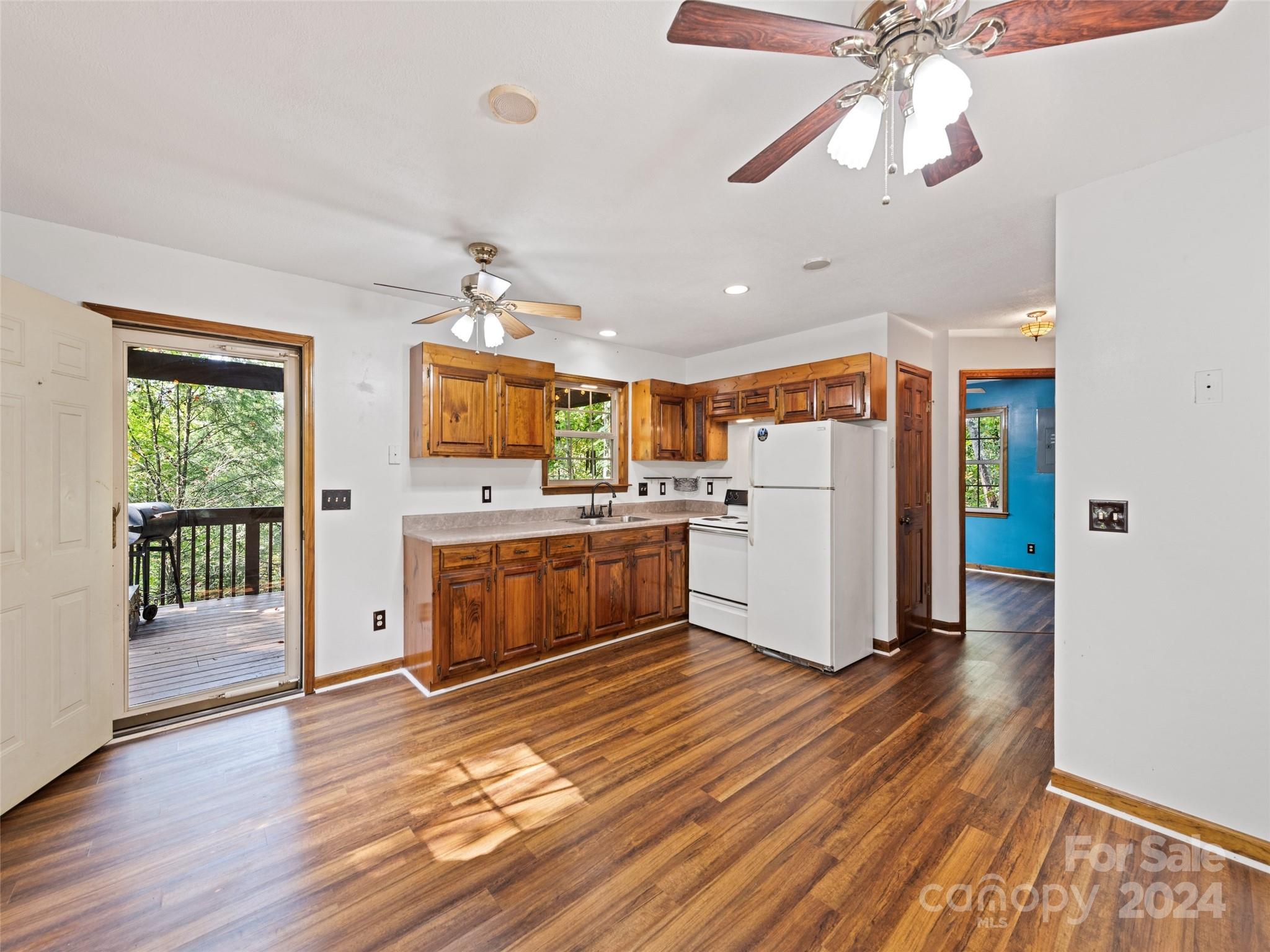626 Rustic Heights Road Waynesville, NC 28785 - Photo 7 of 18 a kitchen with a refrigerator cabinets and wooden floor