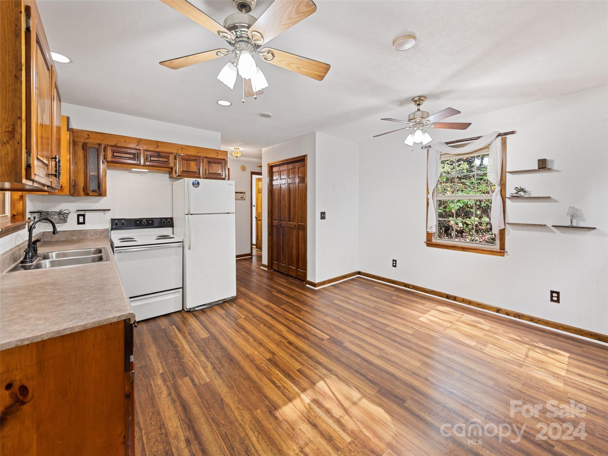 626 Rustic Heights Road Waynesville, NC 28785 - Photo 9 of 18 a kitchen with granite countertop a stove a refrigerator and a sink