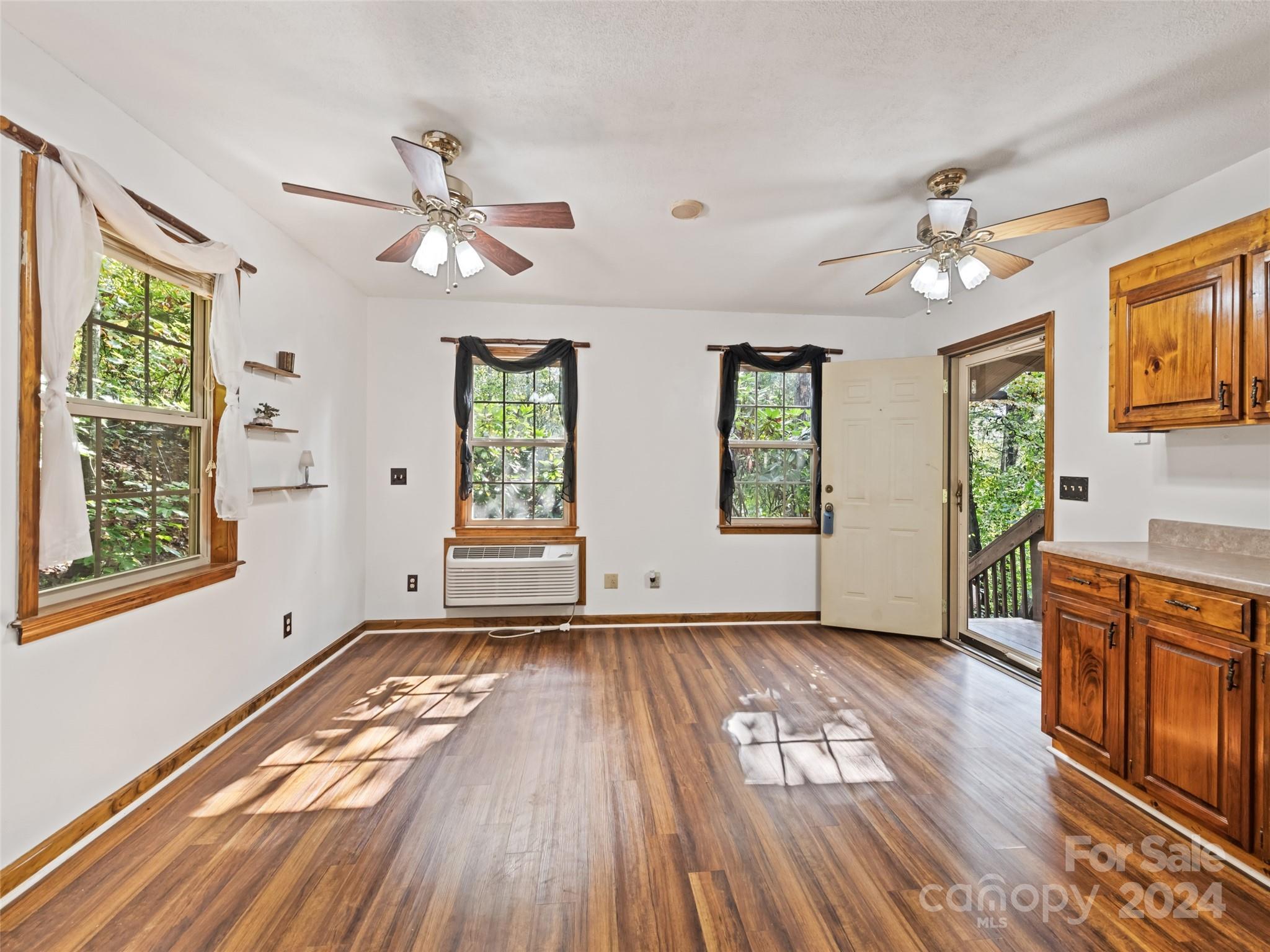 626 Rustic Heights Road Waynesville, NC 28785 - Photo 10 of 18 wooden floor in an empty room with a window