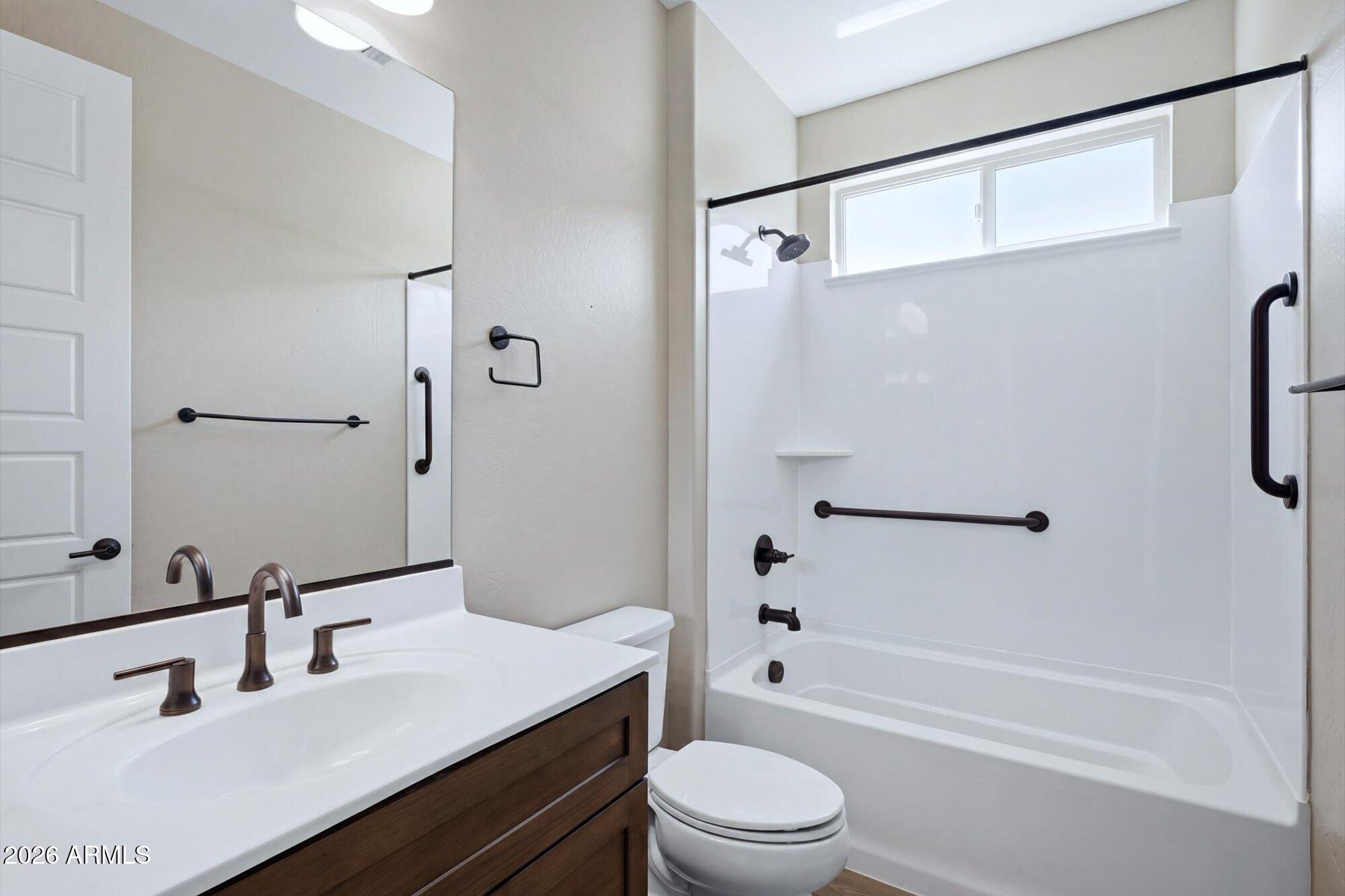 16849 West Merrell Street Goodyear, AZ 85395 - Photo 25 of 35 a bathroom with a bathtub shower sink vanity mirror and toilet