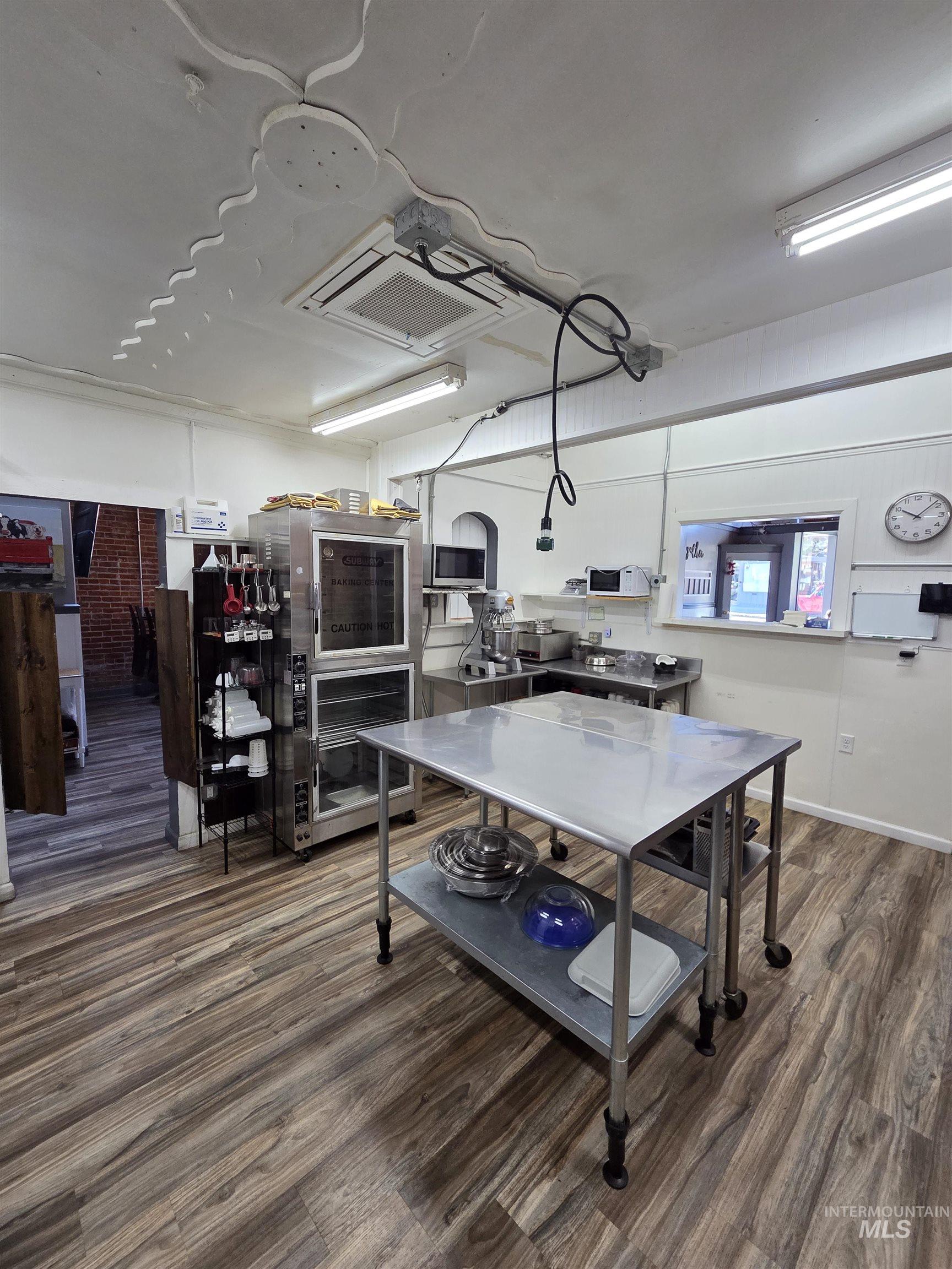 847 Main Street Pomeroy, WA 99347 - Photo 9 of 12 Commercial kitchen space featuring wood-finish flooring and white walls