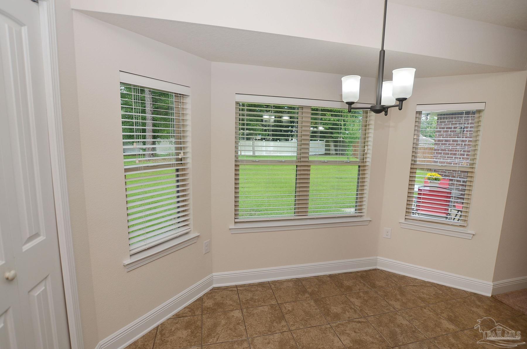5709 Mill Stream Way Pace, FL 32571 - Photo 20 of 48 a view of an empty room with a window