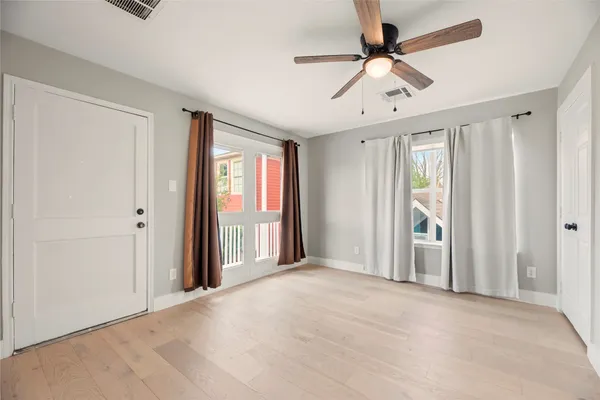 a view of a livingroom with a ceiling fan and window