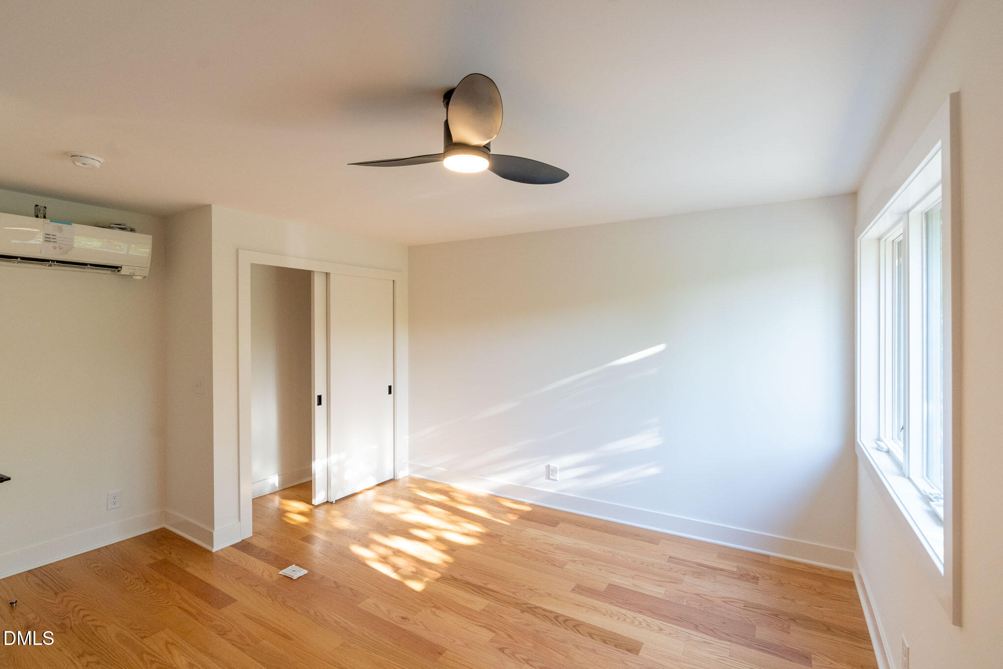 402 East Martin Street Raleigh, NC 27601 - Photo 14 of 23 a view of empty room with wooden floor and fan