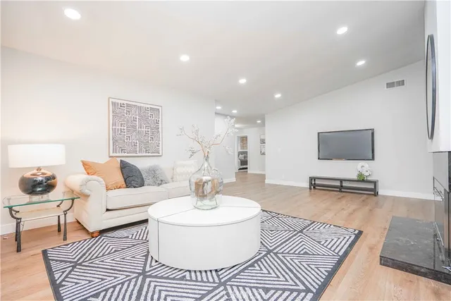 a living room with furniture rug and a table