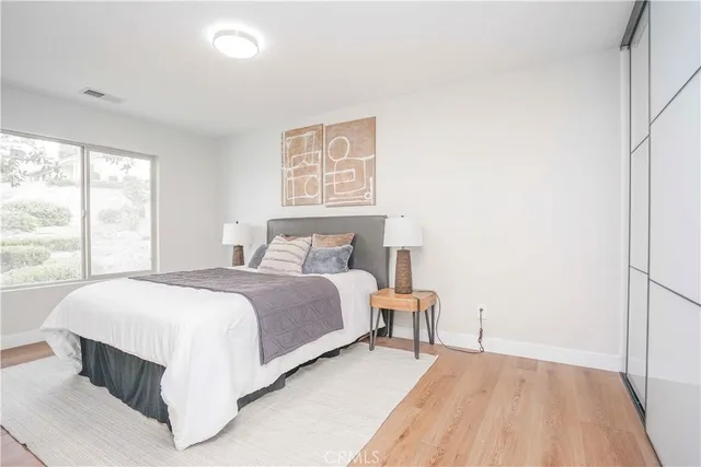 a bathroom with a toilet a sink a tub and mirror