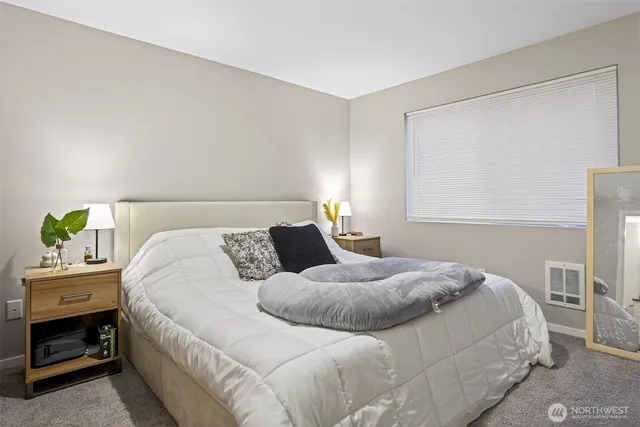 a bathroom with a granite countertop sink a toilet and a mirror
