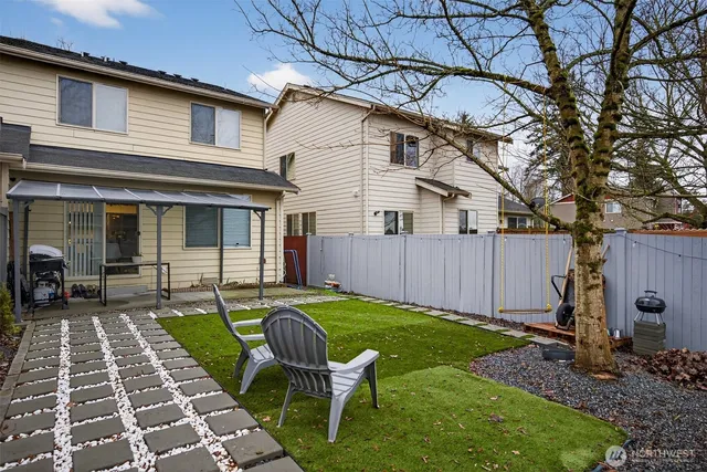 a view of a backyard with sitting area