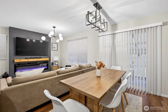 a living room with furniture a chandelier and a flat screen tv