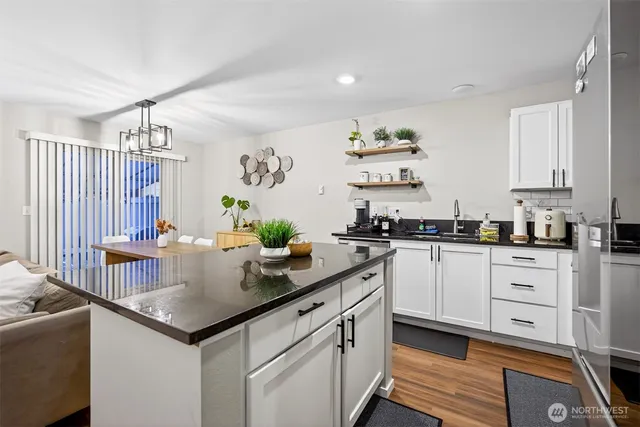 a kitchen with granite countertop a sink and cabinets
