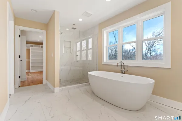 a bathroom with a bathtub and shower