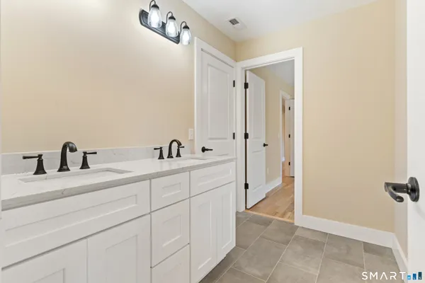 a spacious bathroom with a shower and a sink