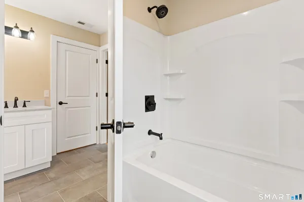 a bathroom with a bathtub and a shower