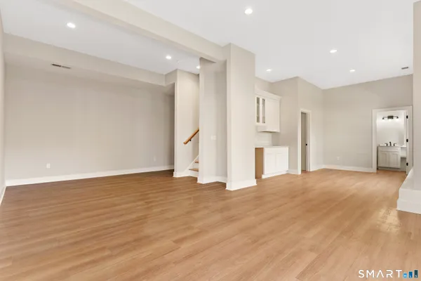 a view of empty room with wooden floor
