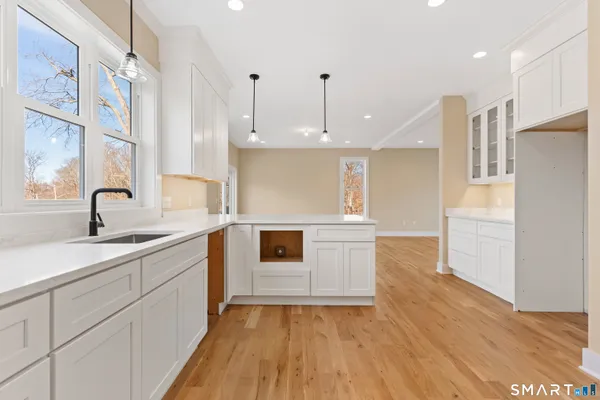 a kitchen with a sink stainless steel appliances and cabinets