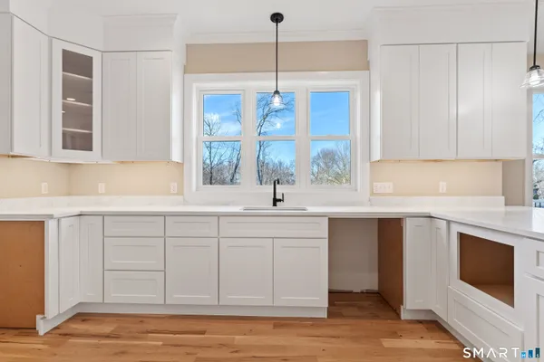 a kitchen with a sink cabinets and window