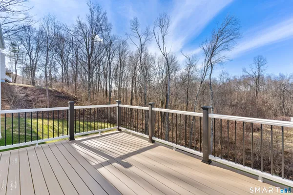 a view of balcony with wooden floor and fence