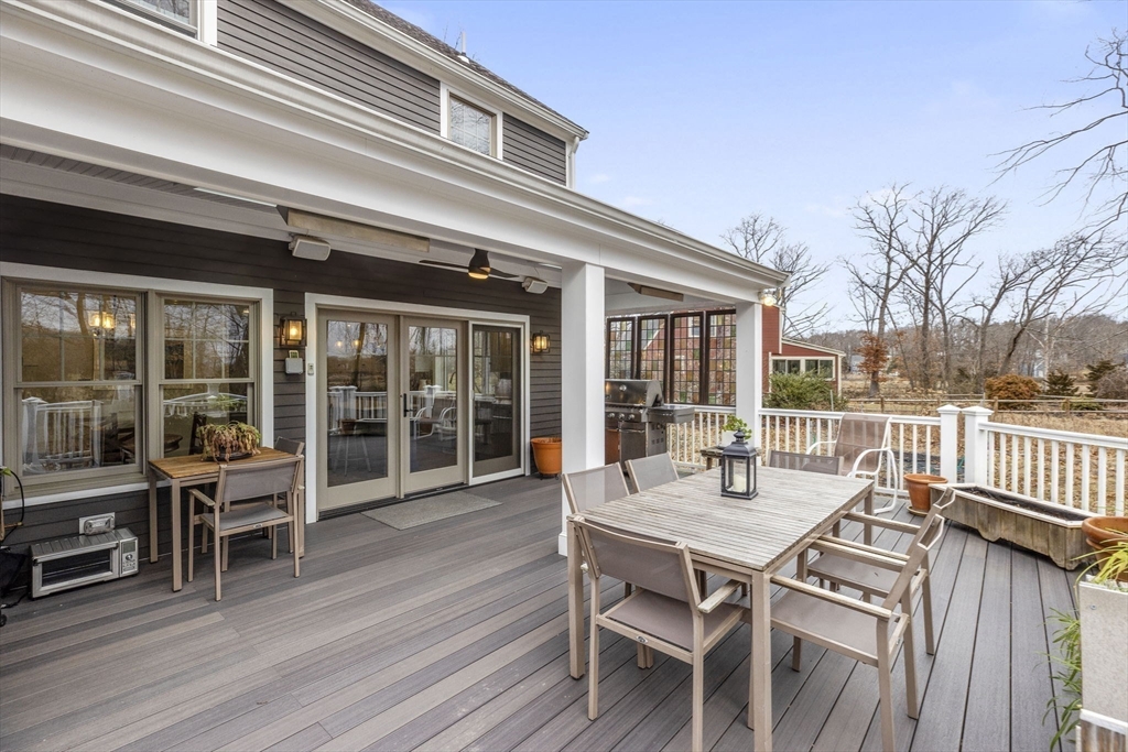 19 Kathy's Path Scituate, MA 02066 - Photo 15 of 41 a view of a patio with table and chairs with wooden floor and fence