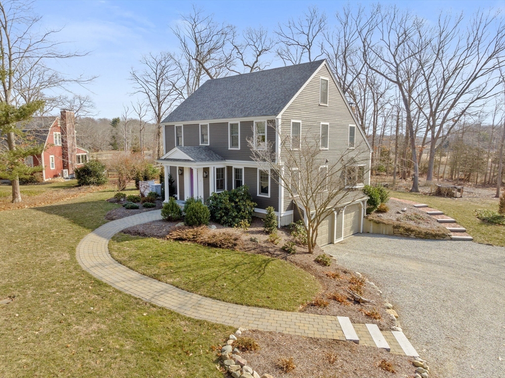 19 Kathy's Path Scituate, MA 02066 - Photo 2 of 41 a view of a white house with a yard patio and fire pit