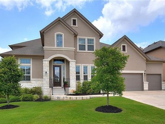 16716 Cory Cactus Drive Austin, TX 78738 - Photo 1 of 1 a front view of a house with a yard and garage