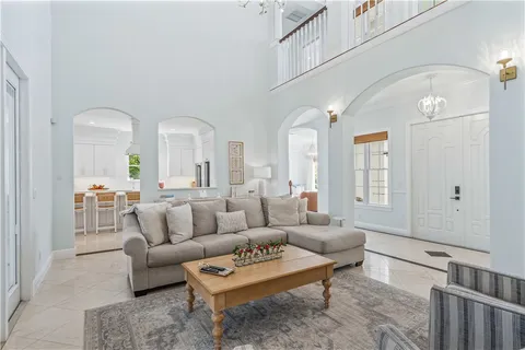 a living room with furniture a rug and a chandelier