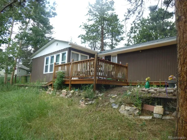 a backyard of a house with yard fire pit and outdoor seating