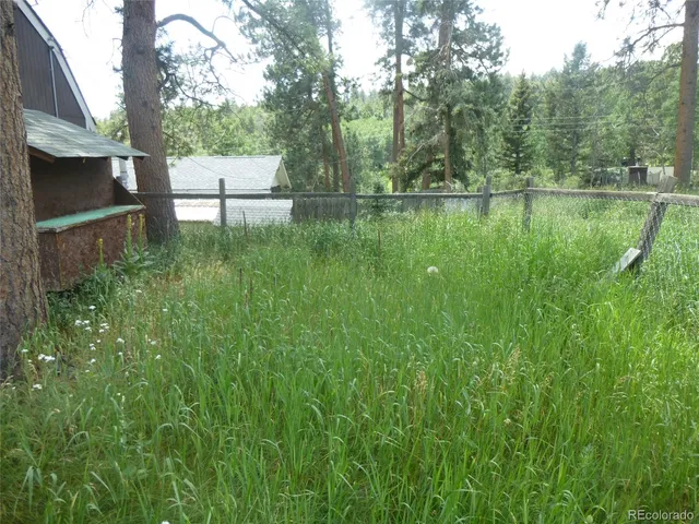 a view of a livingroom with a chandelier fan and a window
