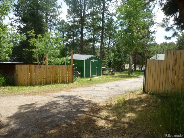 a bathroom with a granite countertop shower and a sink